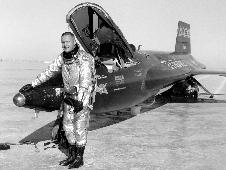 Neil Armstrong standing in front of  X-15 on lakebed