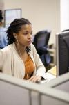 Woman with headphones, on computer