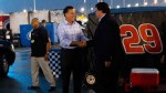 PHOTO: Republican presidential candidate, former Massachusetts Gov. Mitt Romney shakes hands with NASCAR President Mike Helton through the garage area during a rain delay before the start of the NASCAR Sprint Cup Series Federated Auto Parts 400 at Richmon