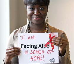 woman holding sign that says 'I am facing AIDS in search of hope!