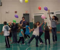 Students participating in the CATCH Kids Club at Moscow Elementary School play balloon games in their gymnasium.
