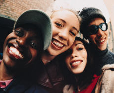 Photograph of a group three female teenagers and one male teenager