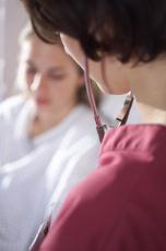 Photograph of a female nurse at the bedside of a woman