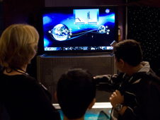 School children viewing a NASA interactive exhibit.