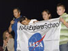 Former astronaut John Herrington presents students at Sanders Middle School, Sanders, Ariz., with a 2006 NASA Explorer School flag.