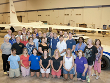 Participants in the two-week AREES workshop gather for a group photo in front of NASA's ER-2 aircraft 806 and its safety chase car.