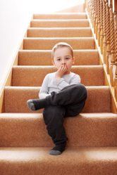 A kid sits on the stairs
