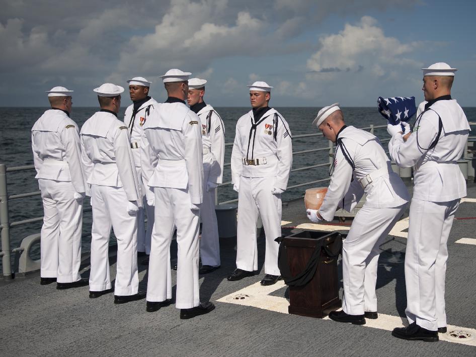 U.S. Navy personnel carry the cremated remains of Apollo 11 astronaut Neil Armstrong during a burial-at-sea service aboard the USS Philippine Sea (CG 58), Friday, Sept. 14, 2012, in the Atlantic Ocean. Armstrong, the first man to walk on the moon during the 1969 Apollo 11 mission, died Aug. 25.