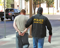 An ICE HSI special agent escorts 23-year-old U.S. soldier following his arrest on child pornography charges