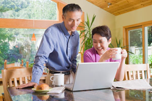 man and woman looking at a laptop