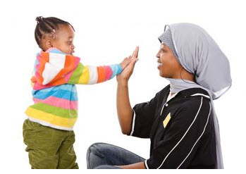 Photo: Adult and child playing high five