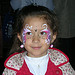 Young girl with face paint at OPM’s Annual Toy Drive