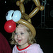 Young girl with balloon hat at OPM’s Annual Toy Drive