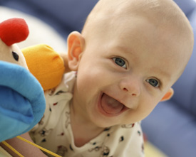 happy baby with soft toy