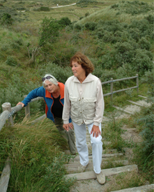 Copyrighted photo of two elderly women walking up an outdoor staircase.