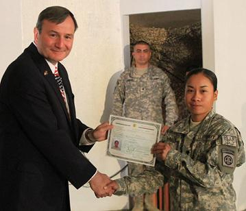 woman receiving certificate at the Afgan citizenship ceremony 2009