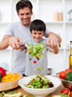 Photo of father and son cooking healthy food.