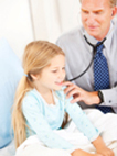 Photo of a doctor using a stethoscope on a little girl.