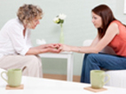 Photo of two women advising each other in a depression treatment center.