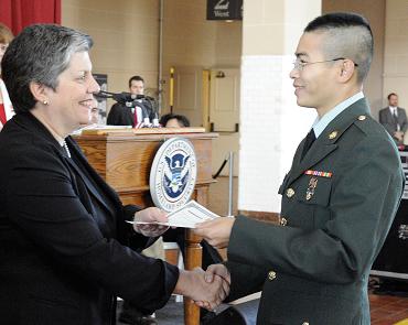 Janet Napolitano gives a certificate to one of the officers