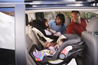Photo: Baby and child in car seat.