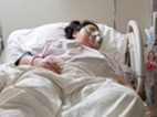 image of  woman in a hospital bed on a mechanical ventilator   