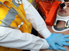 image of emergency medical tech performing chest compressions on a patient   