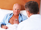 image of doctor talking to an elderly man in bed  