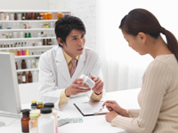 Photo: Woman talking to pharmacist