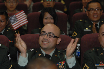 Naturalization candidate waving flag while at the USCIS Ceremony in South Korea