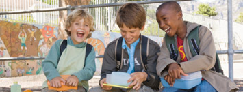 Photo: Three boys laughing on playground