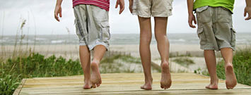 Photo: Kids walking to beach with bare feet