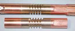 Two copper-alloy spring sample holders.Superconductor wires are soldered to the outer circumference of the springs. Torque applied to the spring puts the wires into tension or compression.