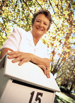 A woman standing by her mailbox