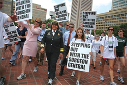 U.S. Surgeon General Regina Benjamin walking with others