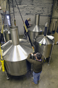Two customers prepare their cans for calibration in PML’s Fluid Metrology facility.