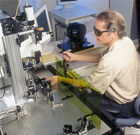 Physicist Dr. Thomas W. LeBrun uses a special joystick to manipulate nanowires with "optical tweezers."