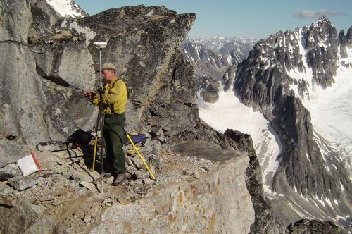 surveyor on cliff ledge