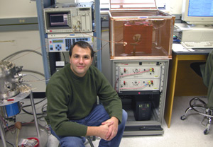 Mike Schneider next to cryogenic and room-temperature pulsed inductive microwave magnetometers.