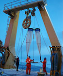 People deploying sampling nets from the stern of the Healy.