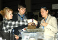 Young woman showing two children the interactive NSF exhibit at 2011 AAAS meeting.