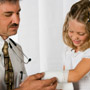 Photo: Doctor bandaging a girl's arm