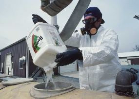 man pouring pesticides