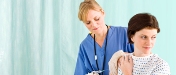 Photo of a woman getting a shot from a health care provider