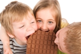 Children eating giant chocolate bar