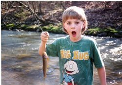 Picture of child - Nate - with his first fish. Photo by Wayne S. Davis ©