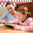 Mother and daughter reading menu at restaurant