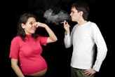 Man smoking near a pregnant woman