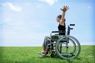 A woman in a wheelchair stretching her arms