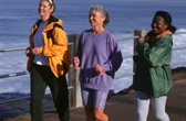 Three women walking along pier